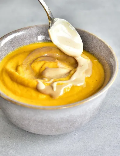 Carrot-coconut soup with peanut butter sauce