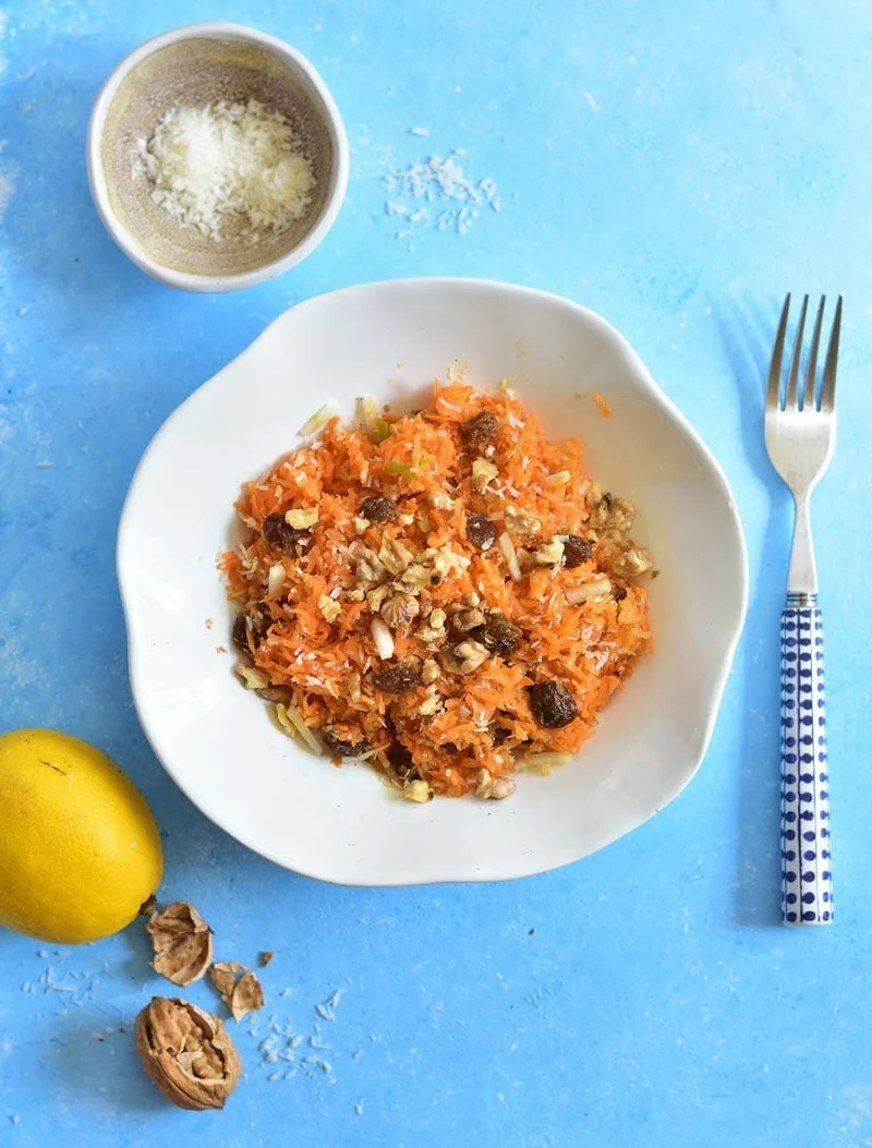 Carrot apple salad with raisins, cinnamon, walnuts and coconut