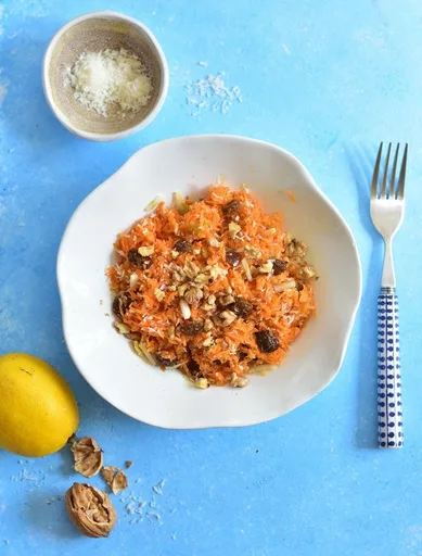 Carrot apple salad with raisins, cinnamon, walnuts and coconut