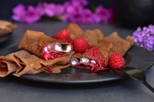Crepes de chocolate con requesón de vainilla y salsa de frambuesa