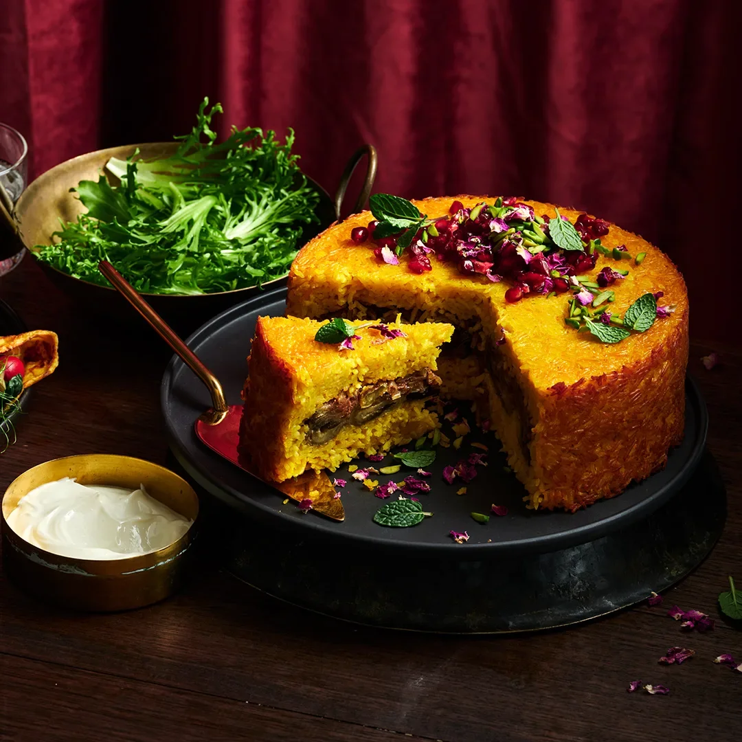 Tachin with caramelised onion, pomegranate and pistachios