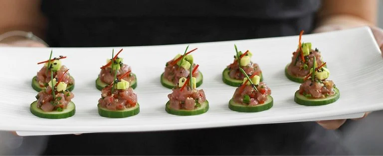 Cucumber slices with tuna and avocado tartare