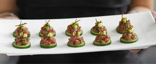 Cucumber slices with tuna and avocado tartare