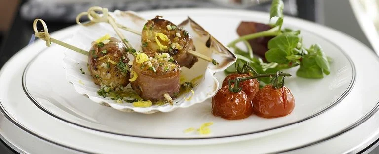 Prosciutto-wrapped scallops with lemon and parsley butter