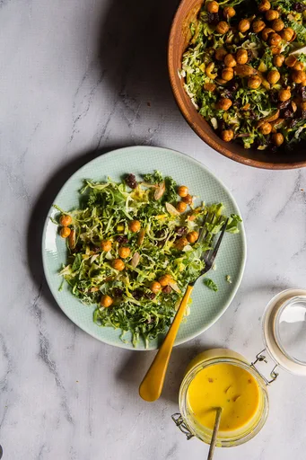 Kale and Brussel Sprouts Salad with Turmeric Honey Yogurt Dressing