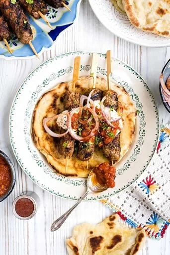 Lamb giaortlou kebab - lamb kofta with tomato sauce and yoghurt