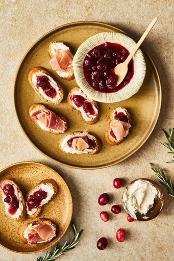Crostinis de queso crema, mermelada de arándanos rojos y jamón serrano