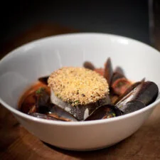 Polenta-crusted Hake with Mussels, Chorizo & Chickpeas