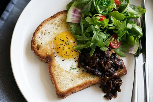 Egg in a Hole Brioche Toast with Bacon Onion Jam