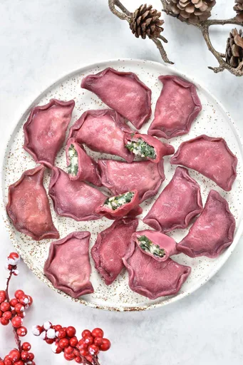 Pink Pierogi with spinach, potatoes and feta cheese filling