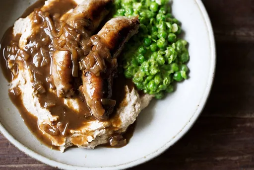 Bangers & Cauliflower Mash with Guinness Onion Gravy & Mushy Peas