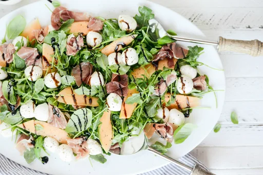 Cantaloupe and Prociutto Arugula Caprese Salad