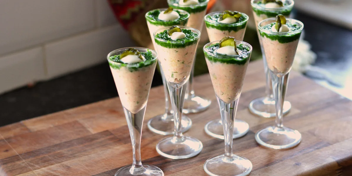 Salmon and crème fraîche shots topped with watercress purée and pickled cucumber