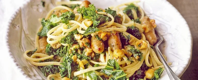 Kale with chipolatas and hazelnuts