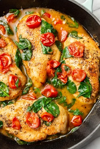 Pollo al vino blanco con tomate y espinacas