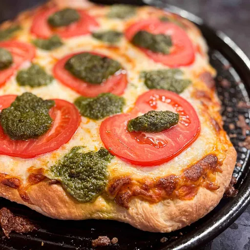 Baked Pesto Pizza With Tomatoes And Mozzarella Cheese Recipe | Sip Bite Go