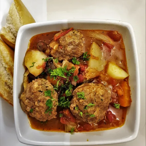Meatball soup with vegetables and tomatoes