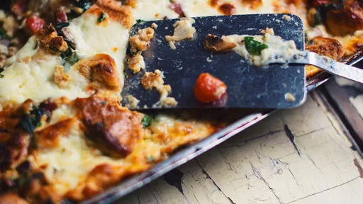 Cheesy strata with bagels, dried sausage and spinach