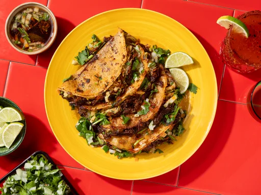 Birria tacos with Consommé (braised beef tacos with rich broth)