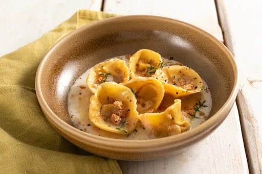 Pumpkin and amaretti-filled cappellacci with provola fondue