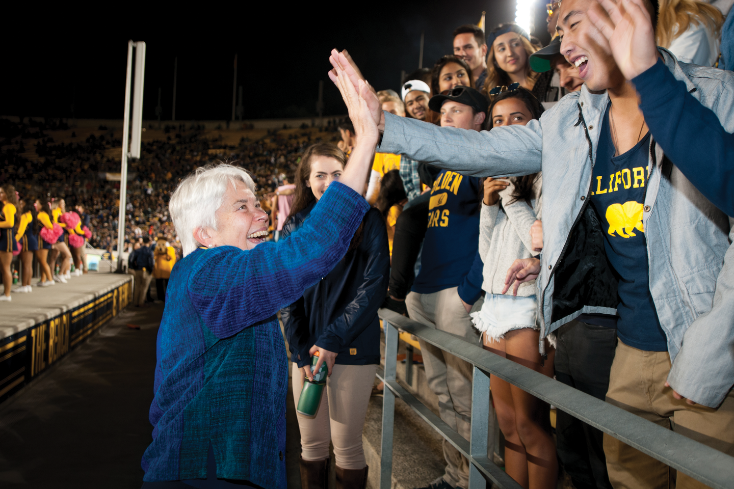 Photo of Chancellor Christ greeting her most exuberant fan club — students.