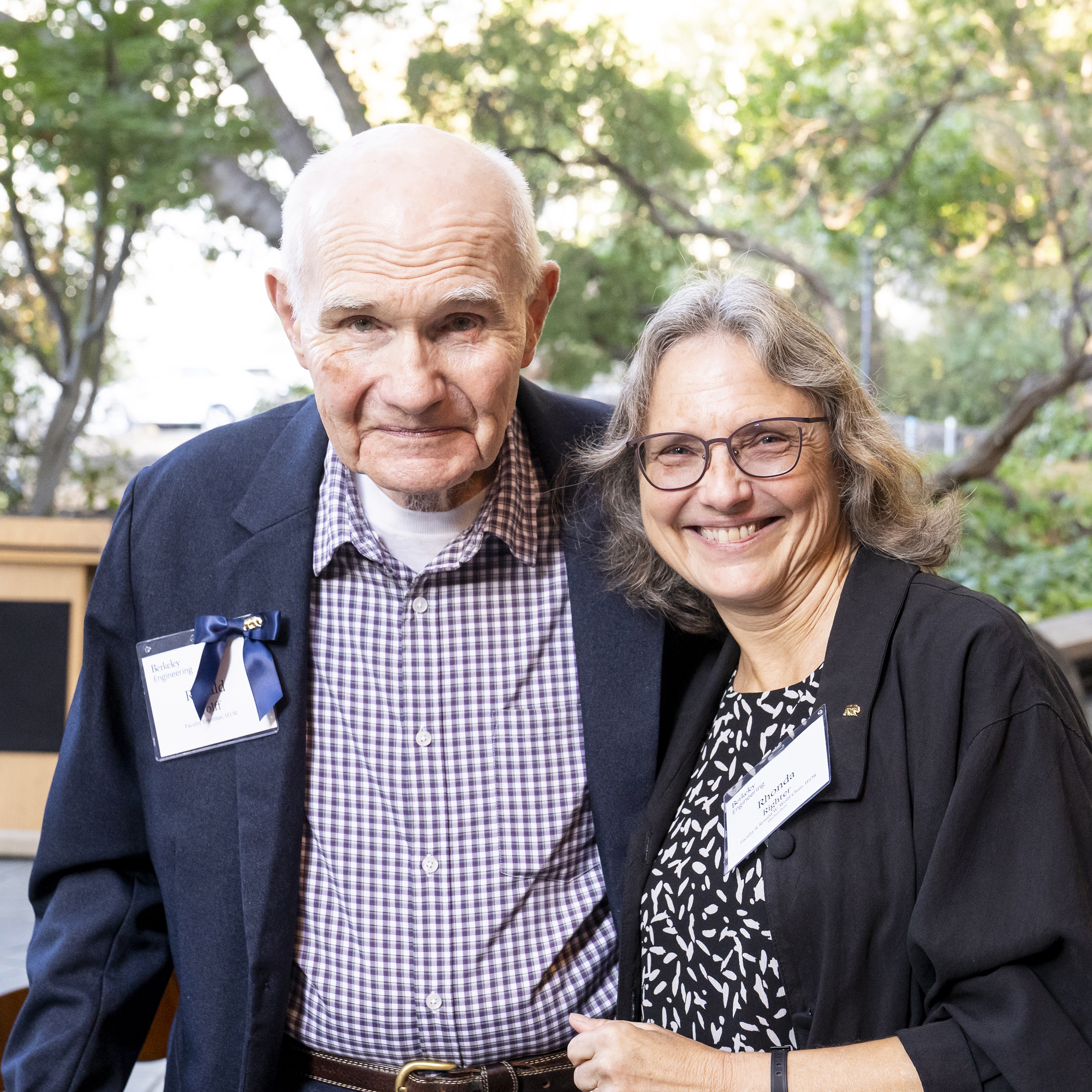 Color photo of two people, smiling into the camera