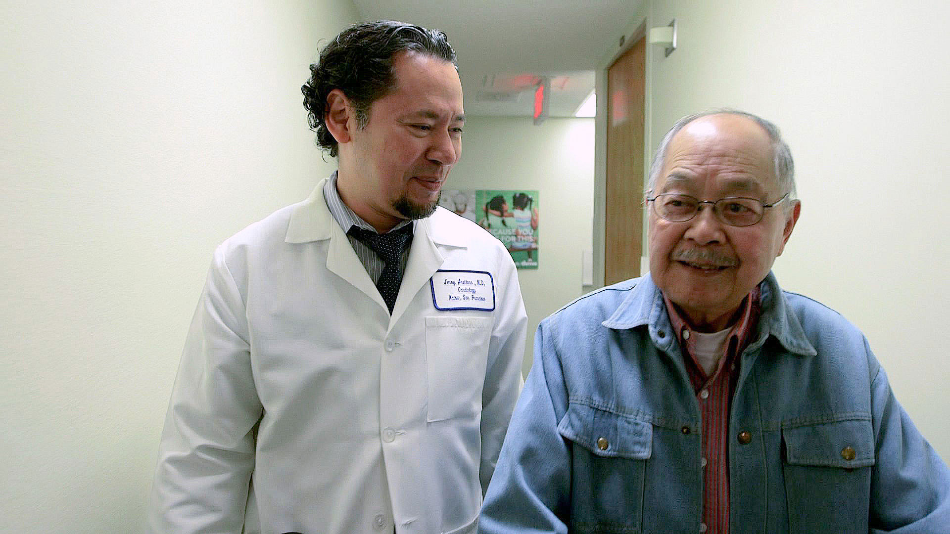 Photo of Jerry in a white doctor's coat walking alongside Wilmer.