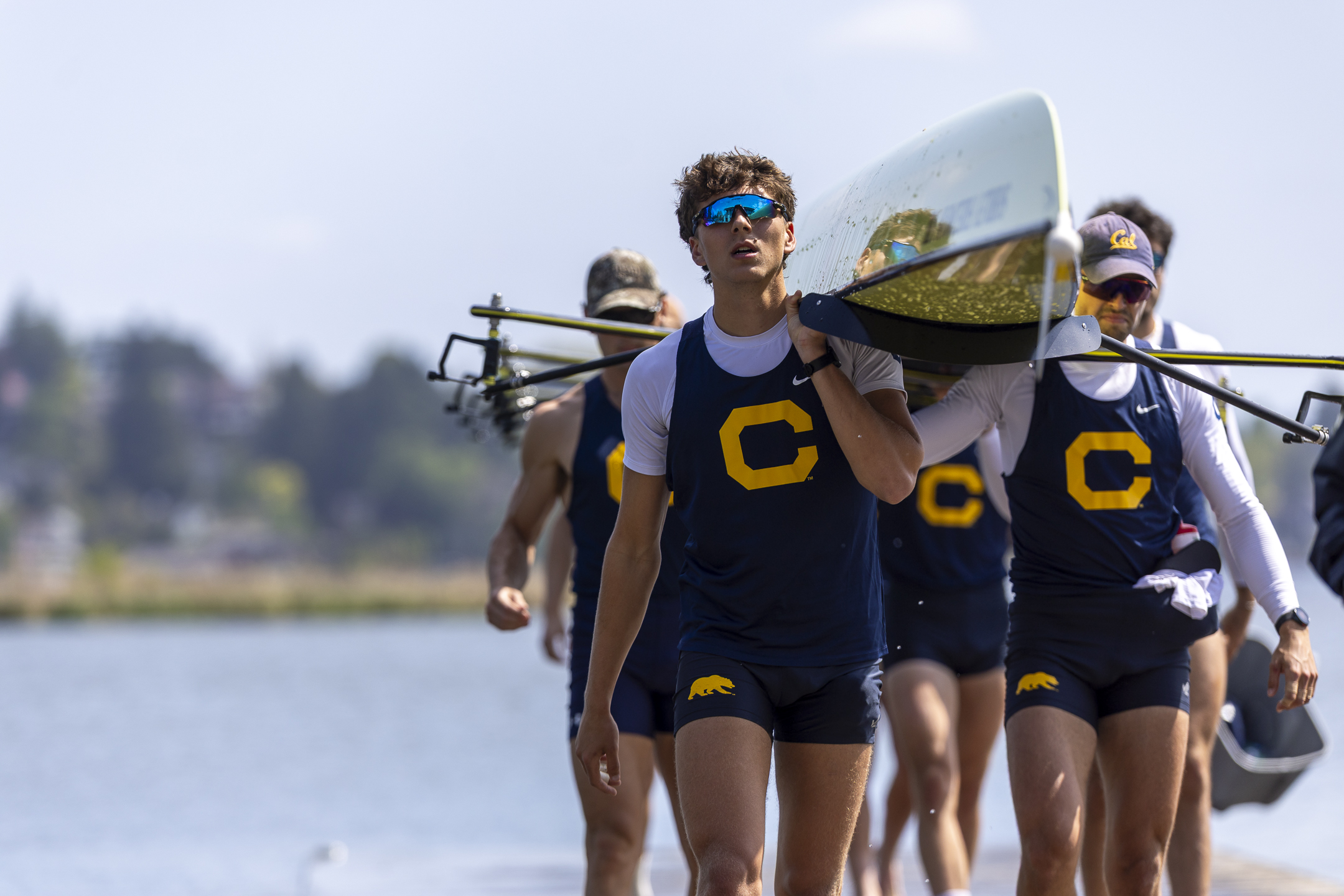 Color photos of student-athletes in Cal Crew uniforms, carrying a boat