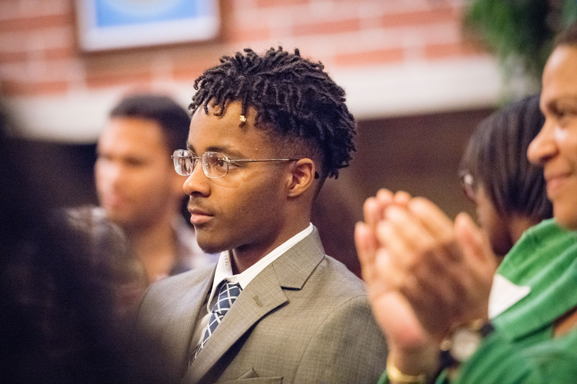 Photo of William Parker listening to remarks during a reception for the scholarship recipients.