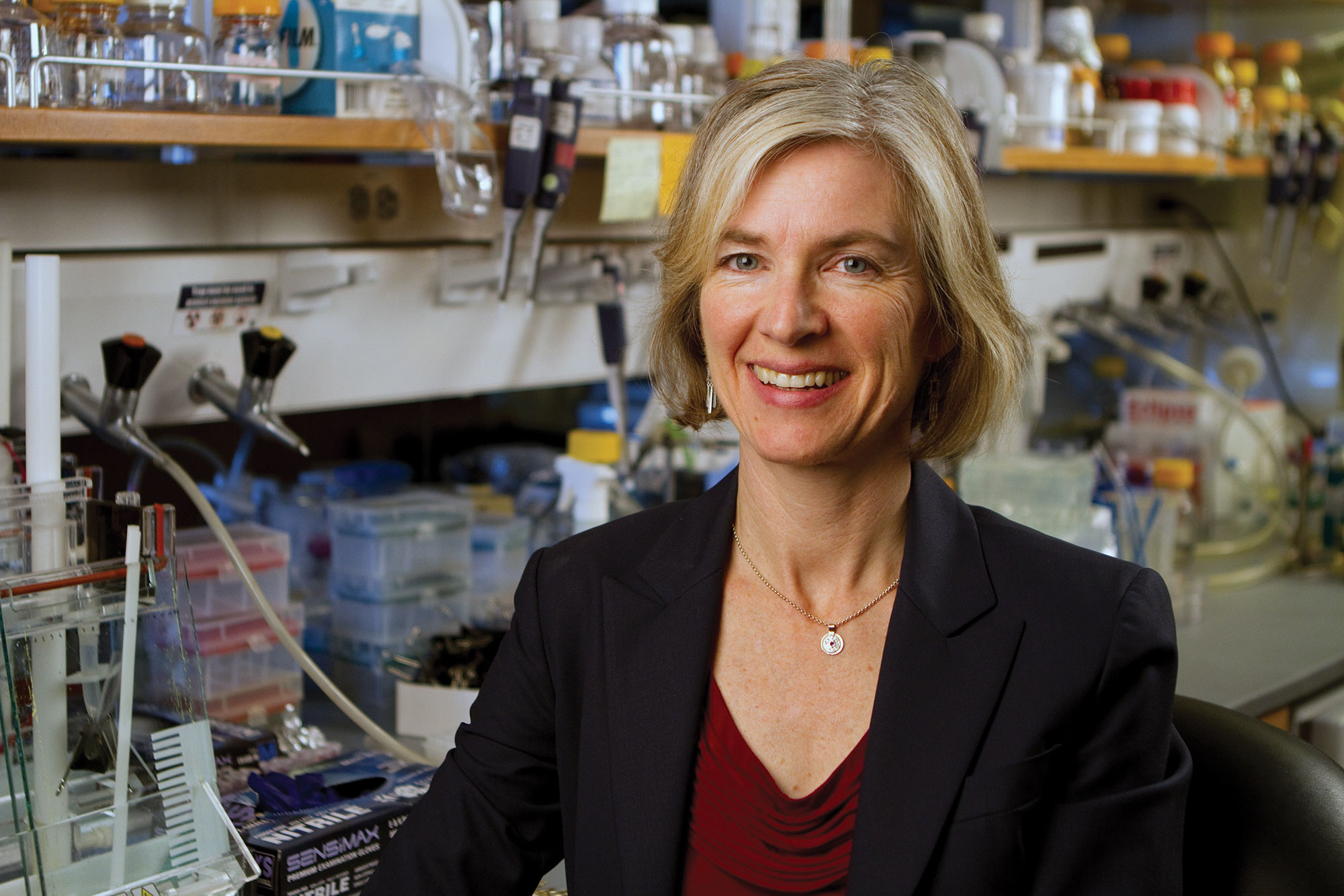 Photo of Jennifer Doudna smiling in her lab