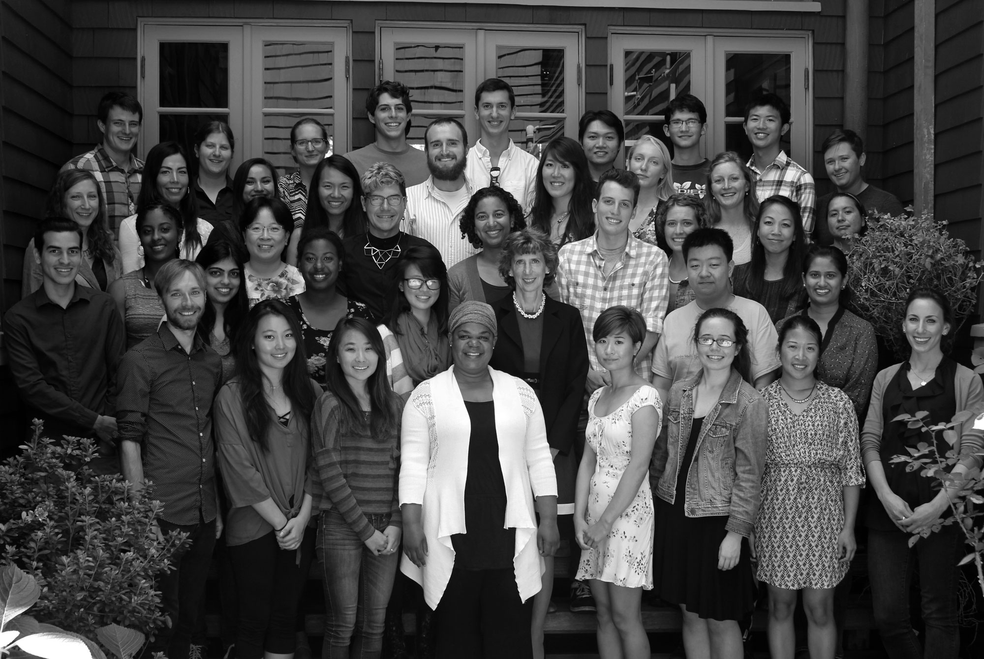 Photo of the dean smiling with approximately 35 graduate stydents.