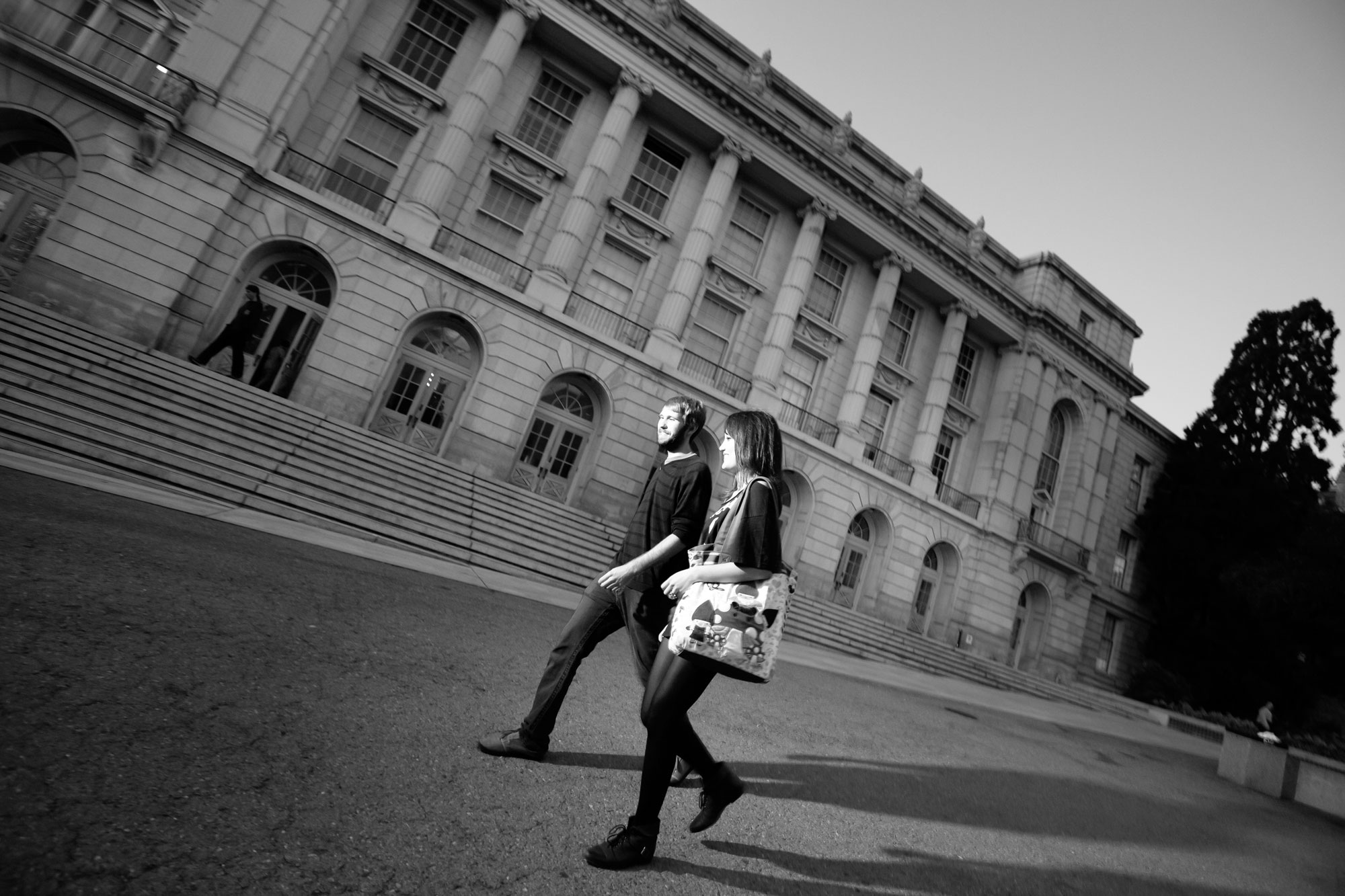 Black-and-white photo of two students passing by Wheeler Hall.