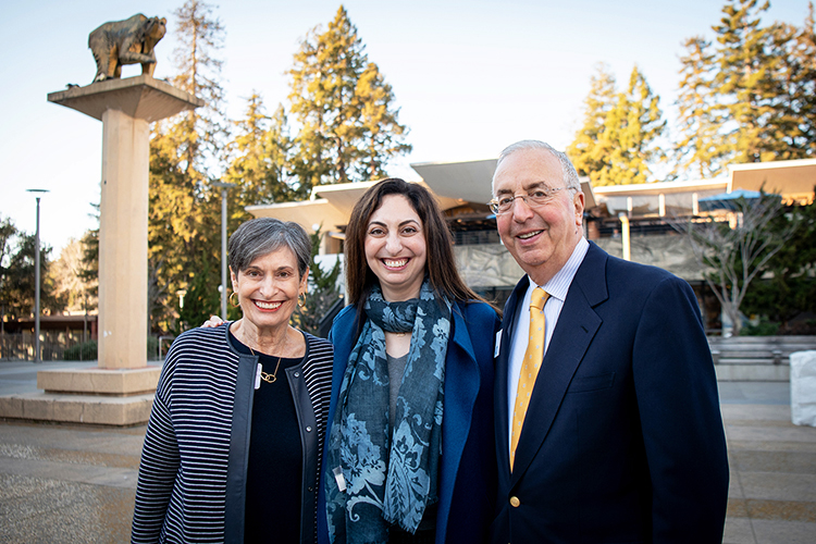 Photo of the Haas family on campus, smiling into the camera