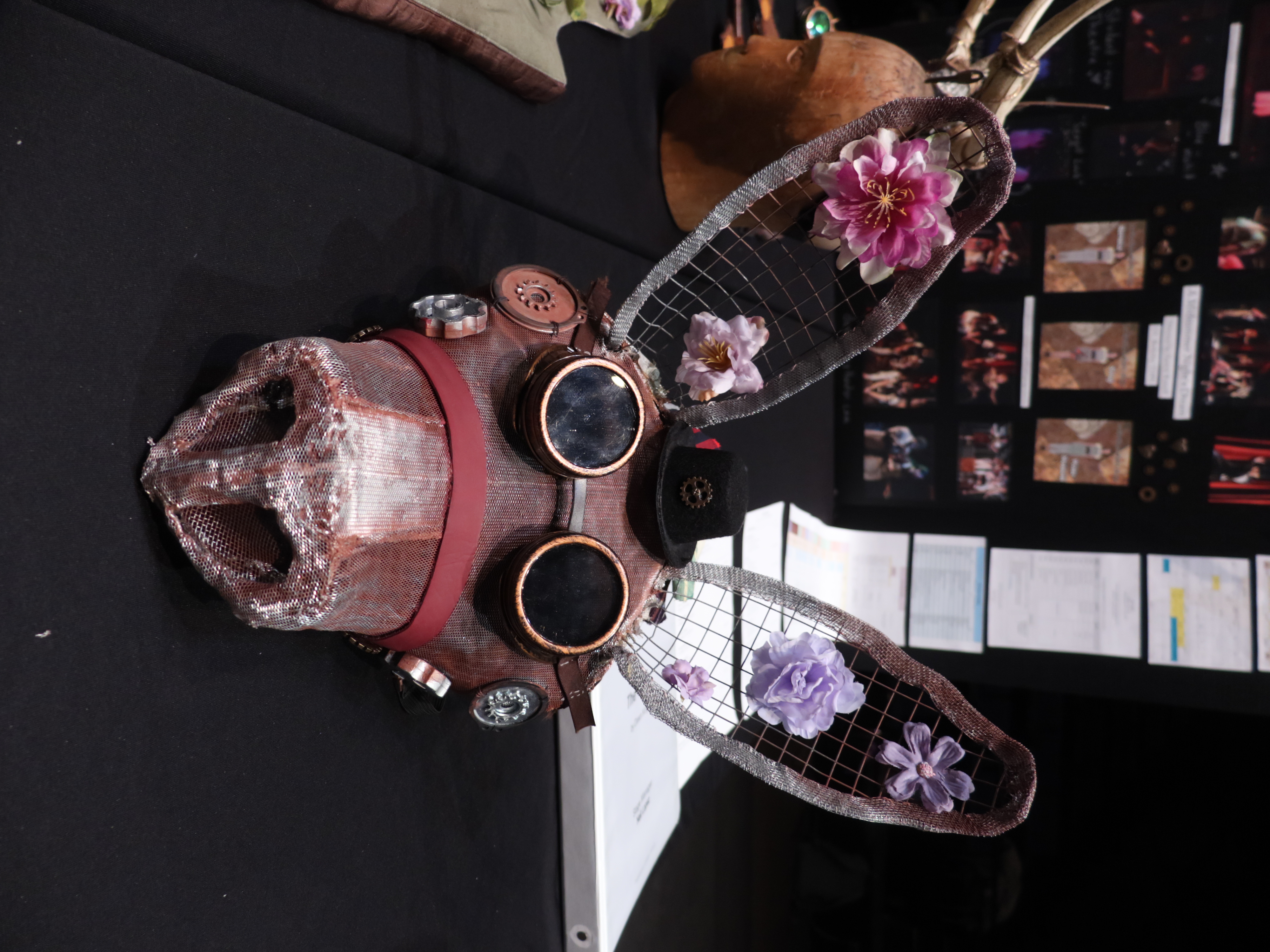 Photo of a donkey mask embellished with goggles, flowers, and other trinkets.