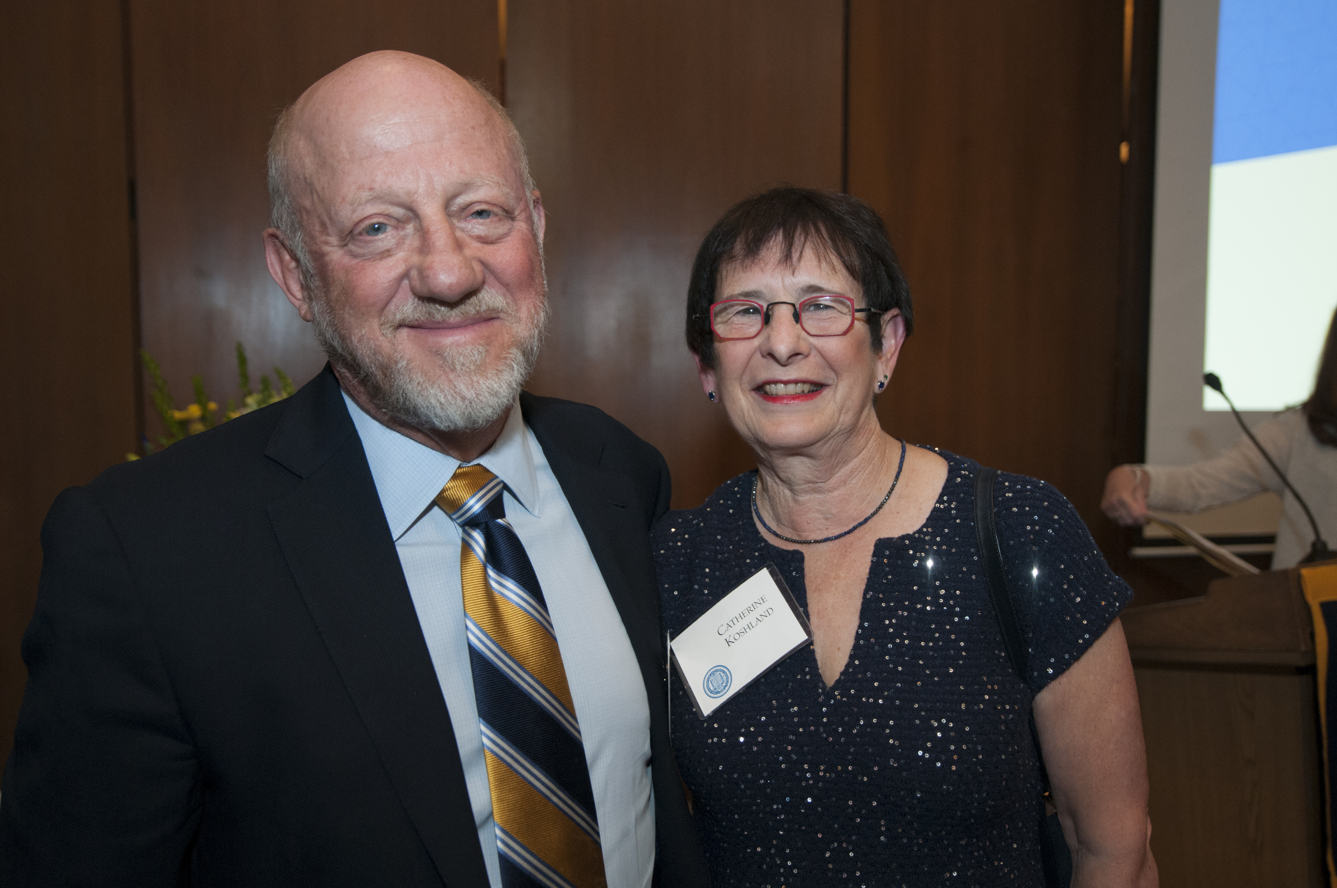 Photo of Jim in a blue-and-gold striped tie and Cathy in a sparkly blue sweater.