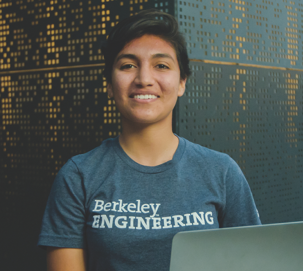 Photo of Lizzette in a Berkeley Engineering t-shirt with a laptop in front of her.