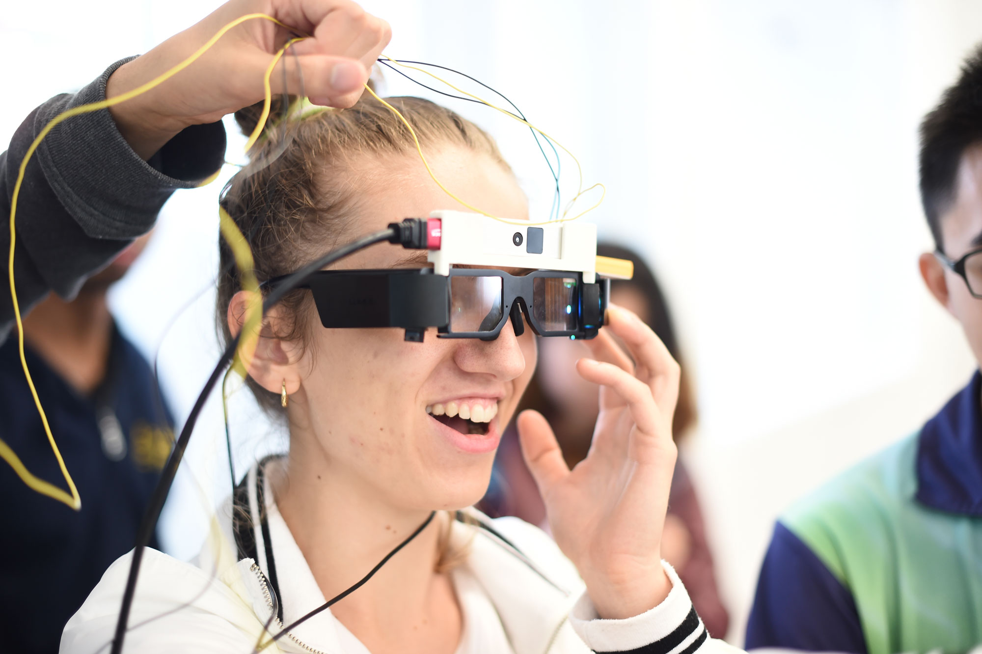 Photo of a student smiling and wearing tech glasses