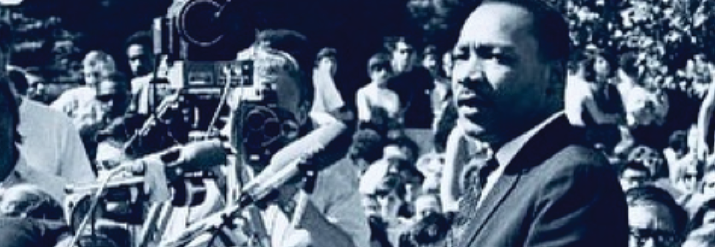 Black and white photo of Martin Luther King Jr. speaking to a crowd