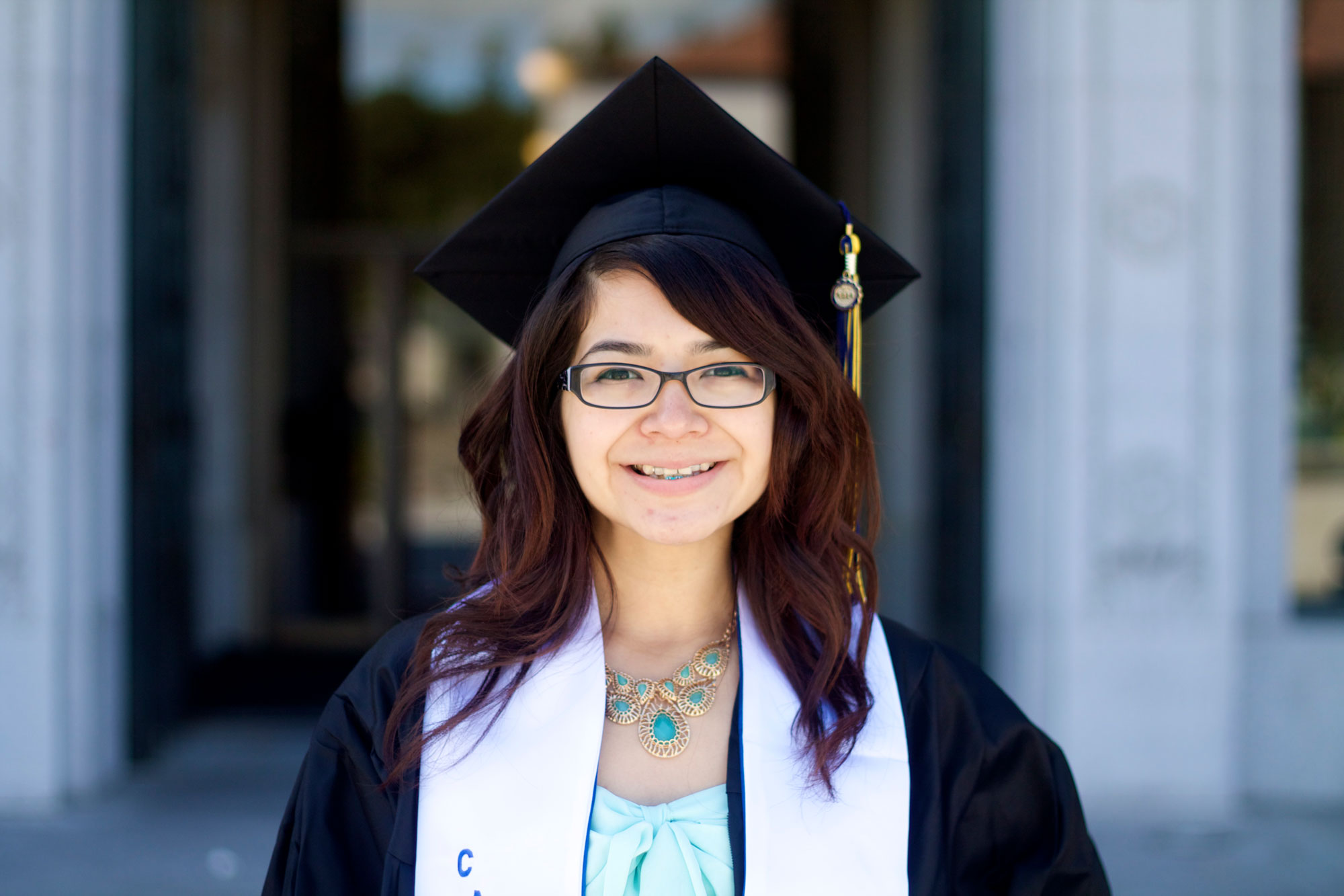 Photo of Maribel in her graduation cap and gown