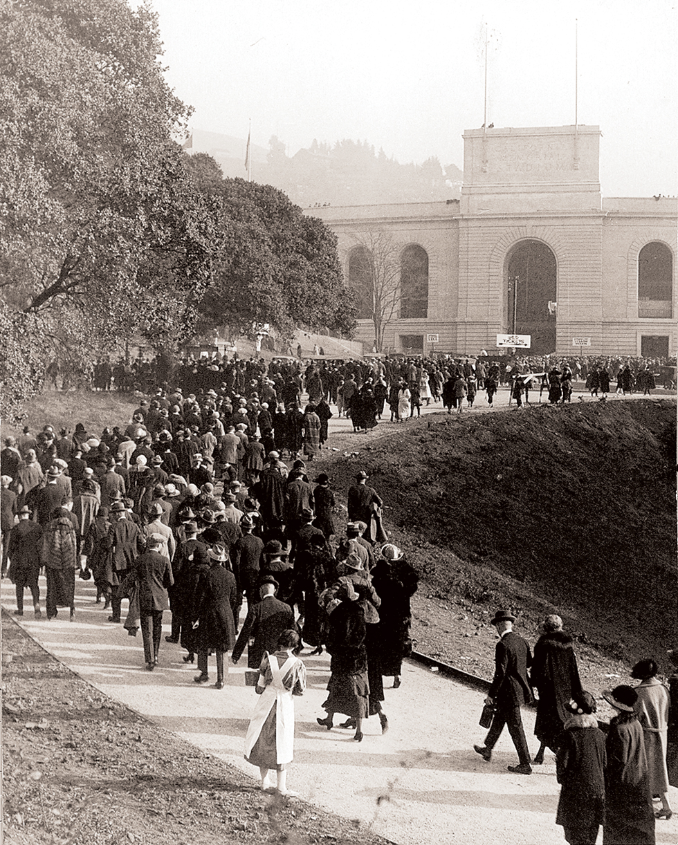 Historic photo of hundreds of people lined up to enter the splendid new stadium.