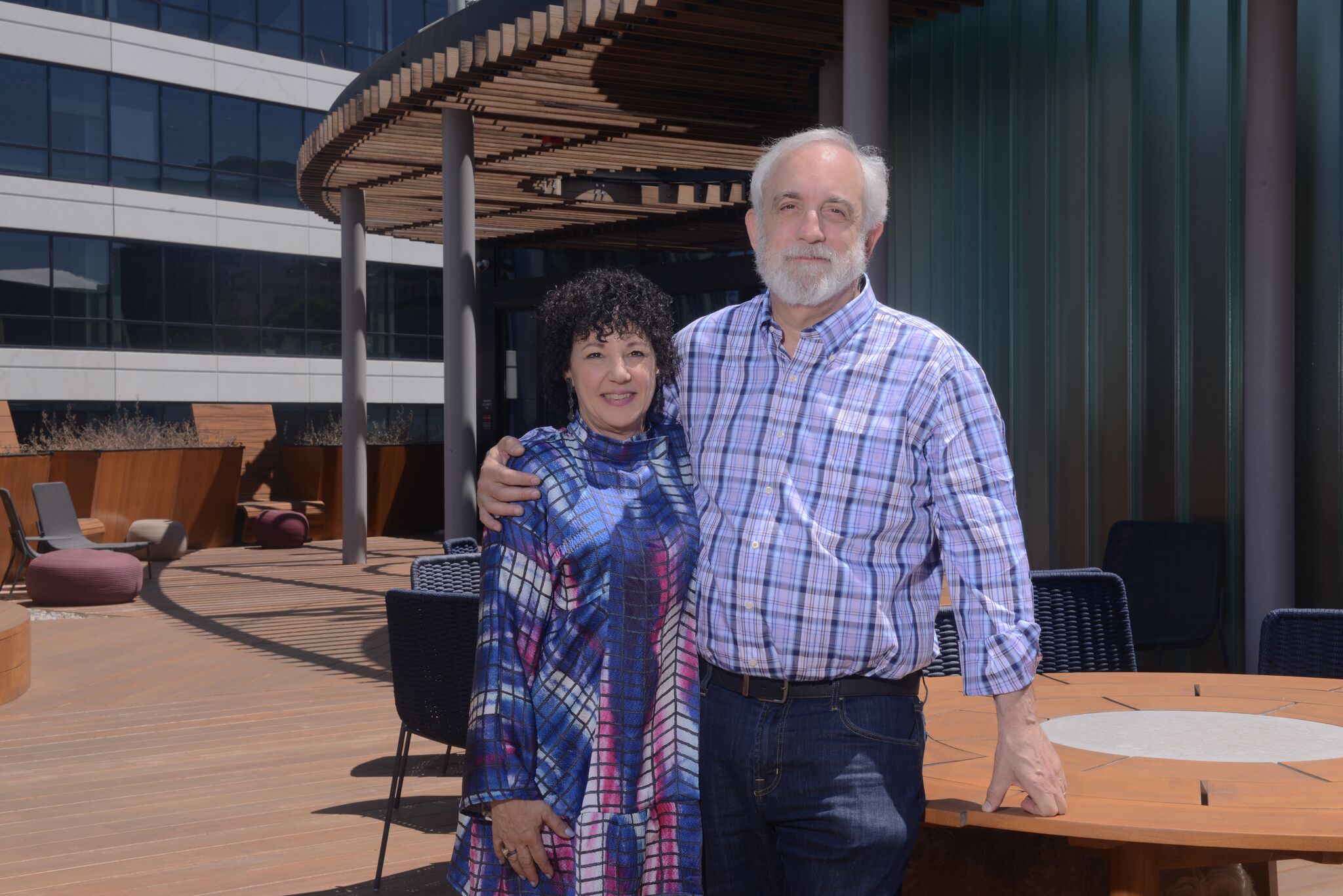 Photo of Freada Kapor Klein and Mitch Klein, arms around each other, smiling at the camera