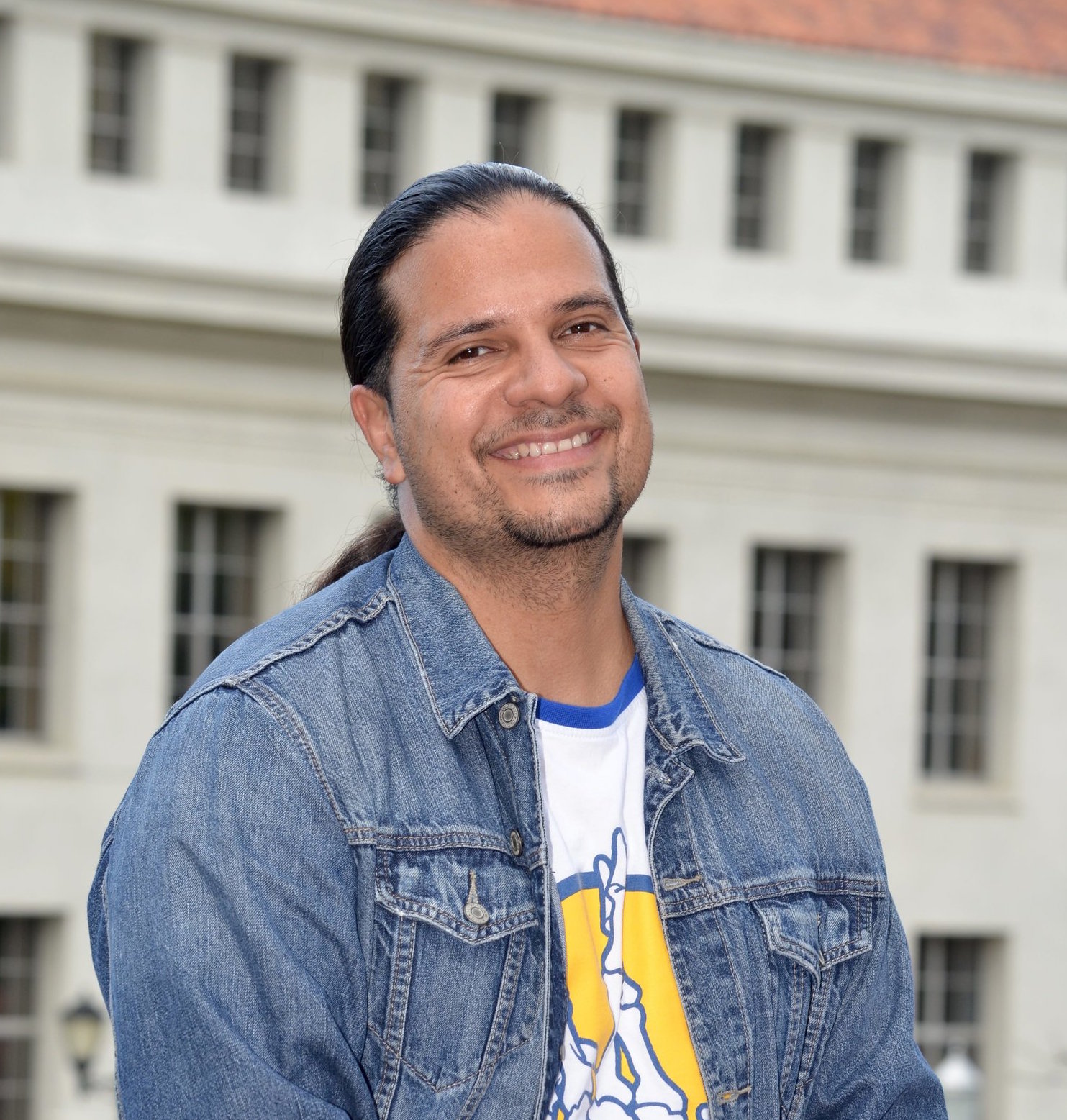 Photo of Pablo smiling in front of a classic Berkeley building