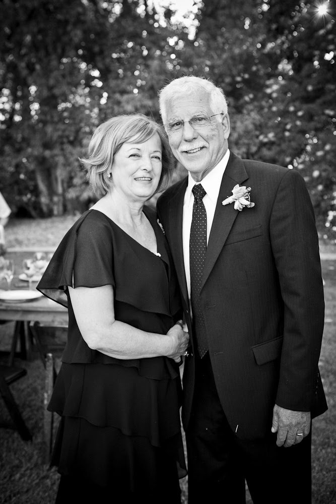 Black-and-white photo of husband and wife smiling.