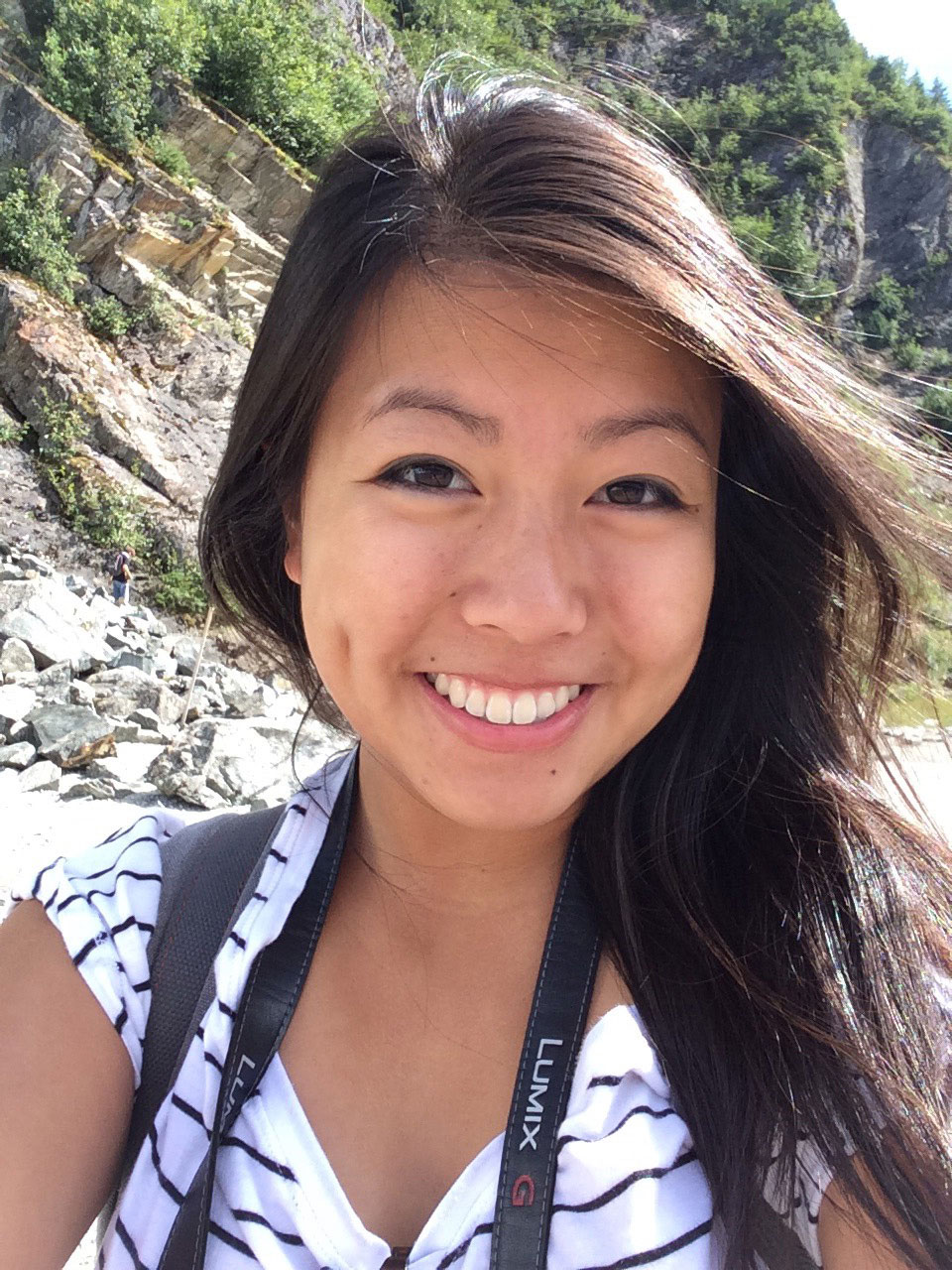 Photo of Sabrina Hua ’19 smiling in a rocky landscape.