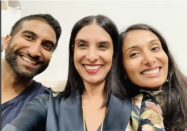 Color photo of Sam and his two sisters, smiling at the camera