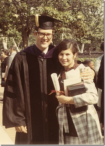 Photo of Tim in his cap gown hugging his wife Ann on his graduation day.