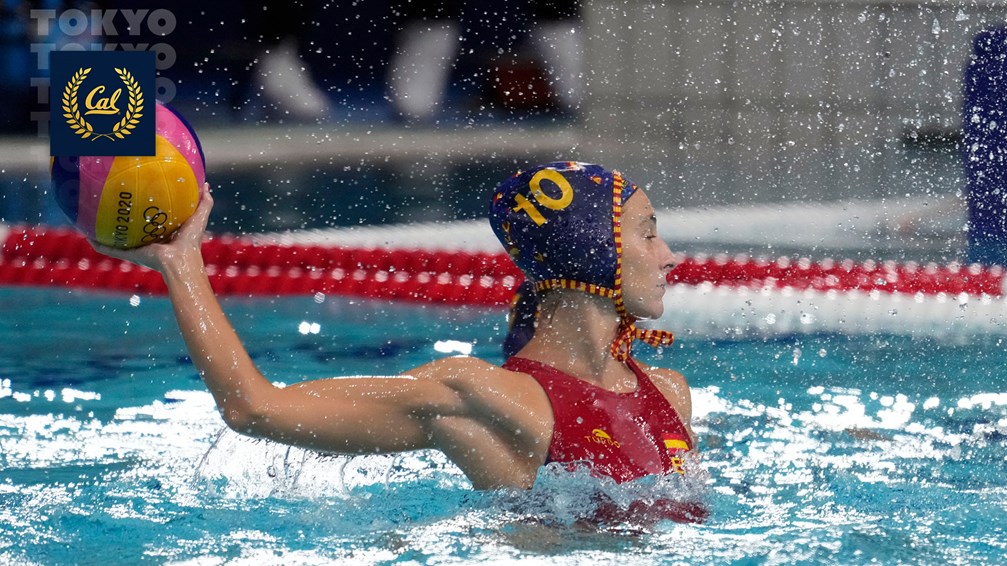 Photo of a water polo player in action in the Olympic pool, ball in her hand poised to throw.