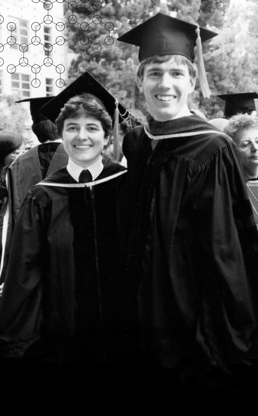 Photo of Ann and Joe wearing their graduation robes and caps.