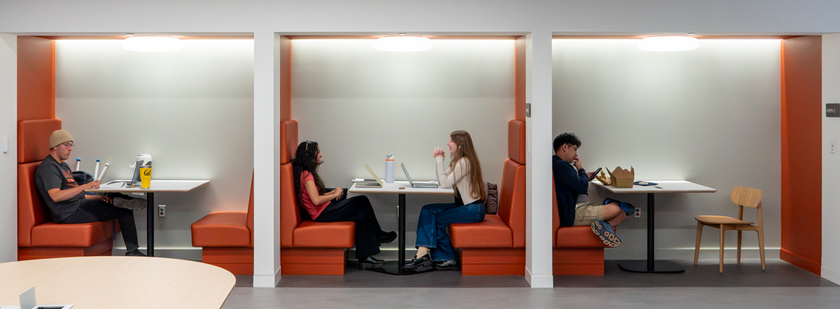 Photo of three study bay with orange booths, students already filling each bay.