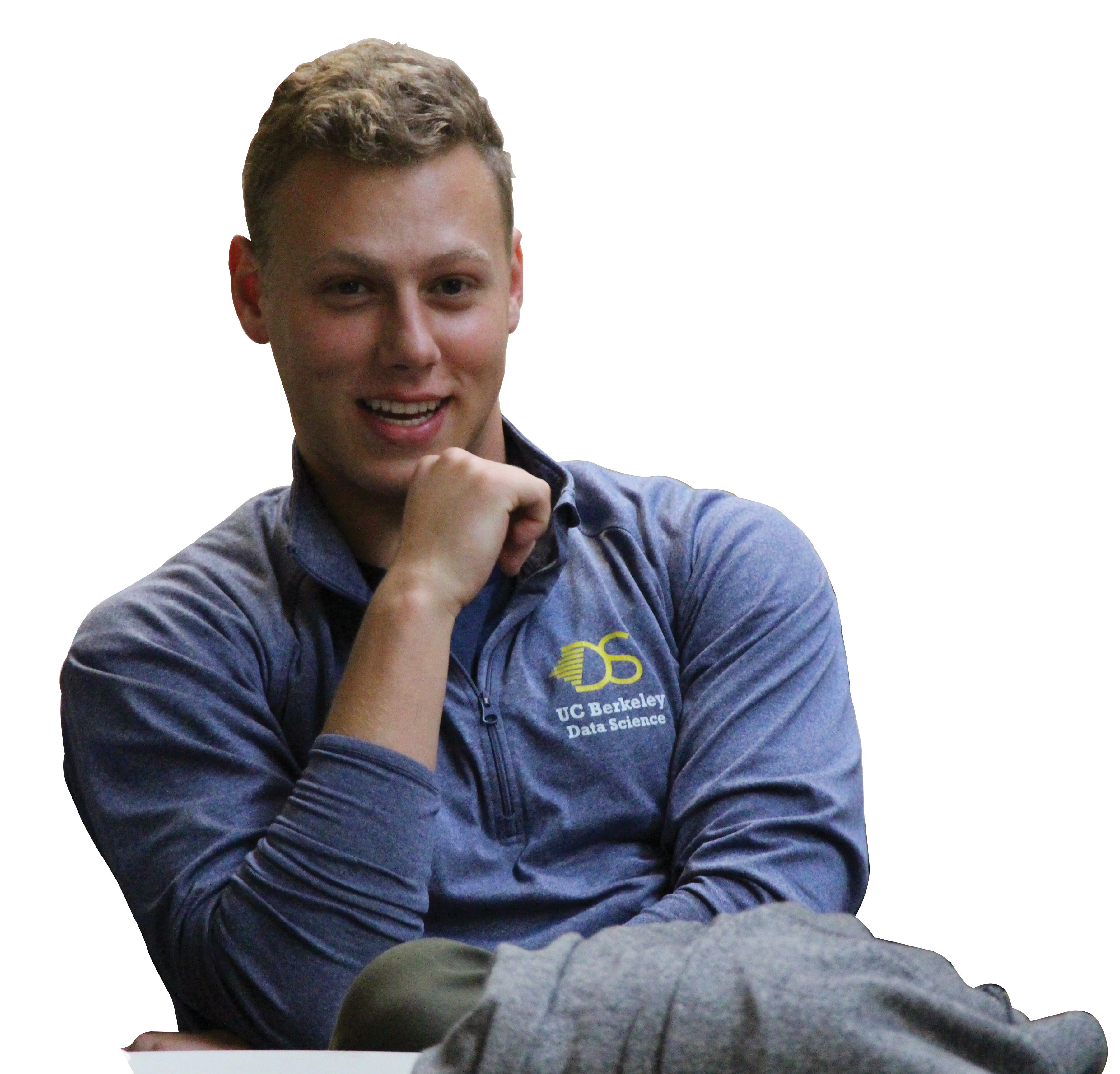 Photo of Alexander Ivanoff ’18 in a blue shirt with a data science logo and his chin resting on his fist.